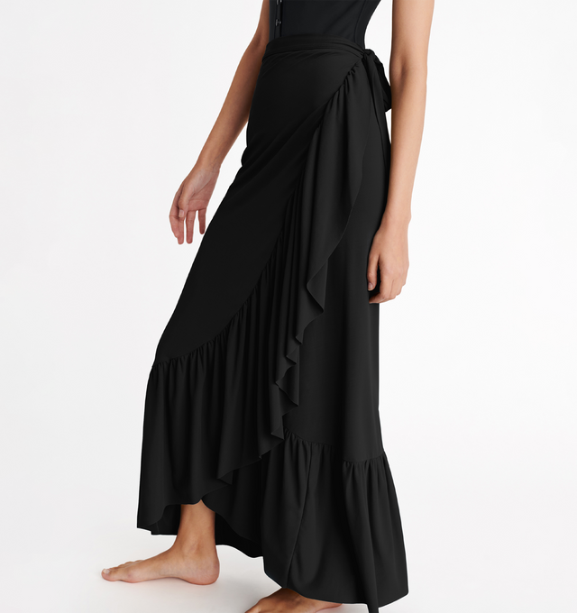 Image 4 of 4 - BLACK - ERES Julia Skirt is a sarong wrap skirt featuring a stitched belt at the waist and ruffles at the hem. 94% Polyamid, 6% Spandex. Made in France. 