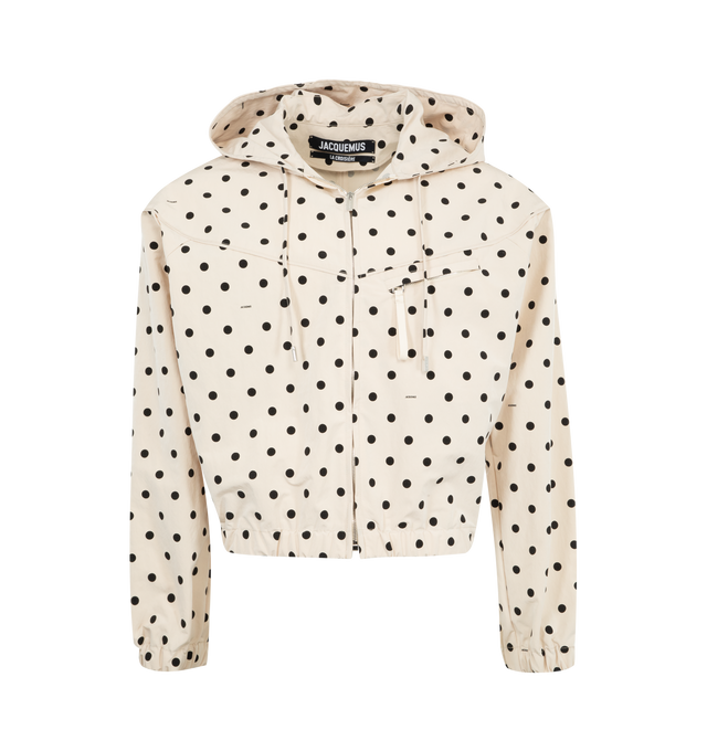 Image 1 of 2 - NEUTRAL - JACQUEMUS Polka-Dot Windbreaker Jacket featuring oversized fit, lightweight polka-dot nylon, drawstring hood with circle and square tips, long sleeves, zipper closure, chest yoke, zipped chest pockets with puller, side-seam pockets, elasticated cuffs and hem and Jacquemus Club label in the back. 68% polyamide, 32% polyester.  