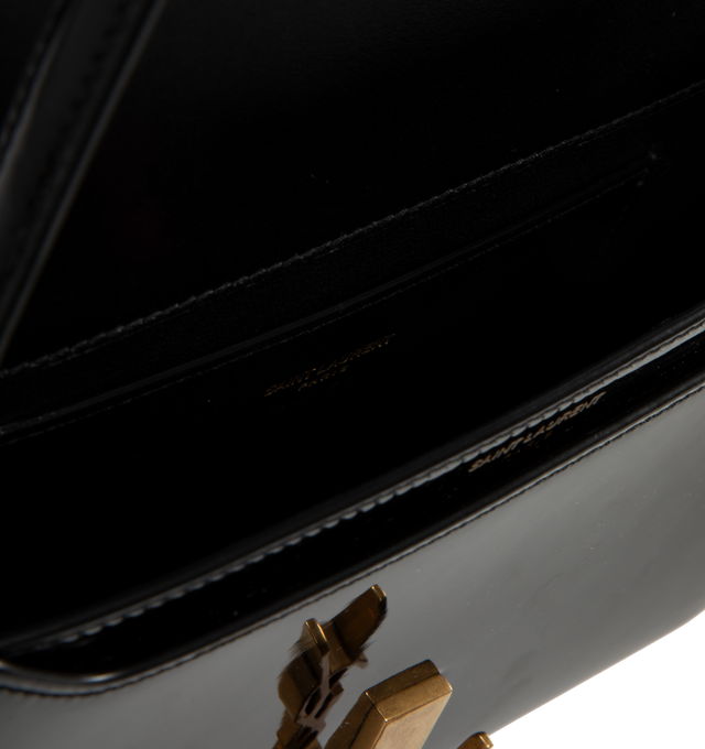 Image 3 of 3 - BLACK - Saint Laurent YSL Hobo Demi Lune has a Cassandre logo hook closure, a fixed belt, and an interior flap pocket. H 4.3 x W 9.83 x D 1.8 Inches. Calfskin leather. Made in Italy.  