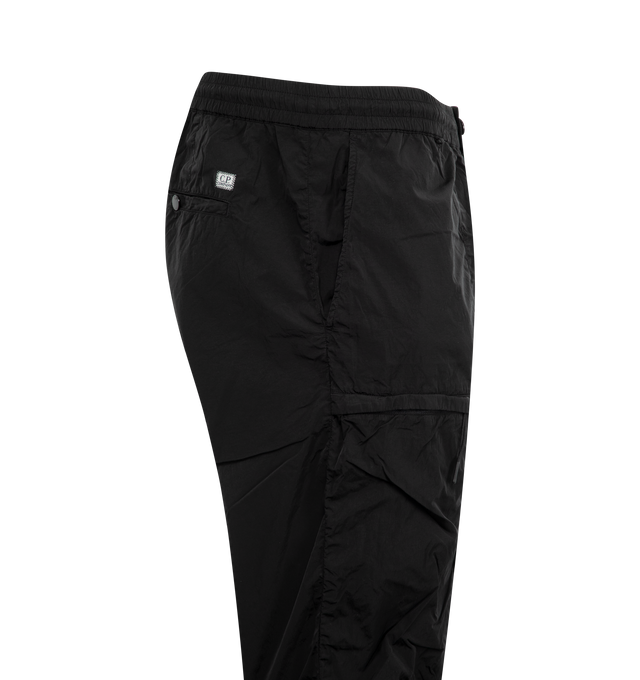 Image 3 of 4 - BLACK - C.P. COMPANY Chrome-R Cargo Lens Pants featuring adjustable drawstring waistband, button and zip fastening, side pockets, cargo flap snap and zip pockets, lens detail, back open pocket with applied logo label, adjustable drawstring hems, garment dyed and regular fit. 100% polyamide/nylon. 