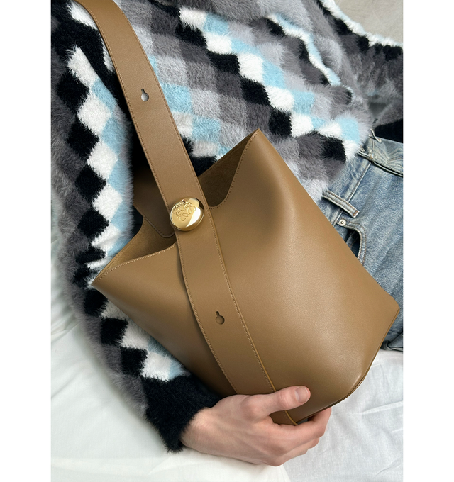 Image 4 of 6 - BROWN - LOEWE Medium Pebble Bucket Bag featuring shoulder or crossbody carry, adjustable strap, magnetic closure, internal pocket, bonded leather lining and Anagram engraved Pebble. 11 x 9.6 x 9.3 inches. Mellow calf. Made in Spain. 