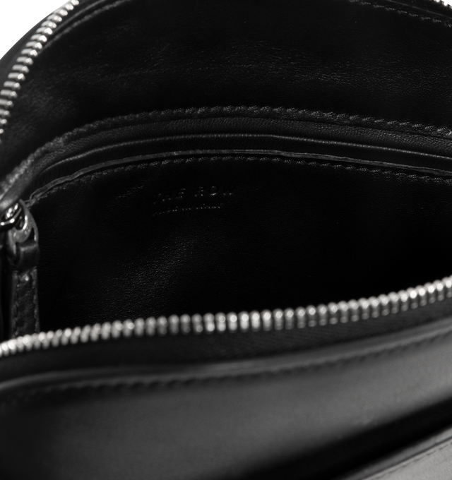 Image 3 of 3 - BLACK - THE ROW E/W Annie Crossbody Bag featuring curved crossbody bag in textured calfskin leather with exterior slot, adjustable shoulder strap and zipper closure. 8.5 x 5.7 x 2.6 in. 100% calfskin leather. Made in Italy. 