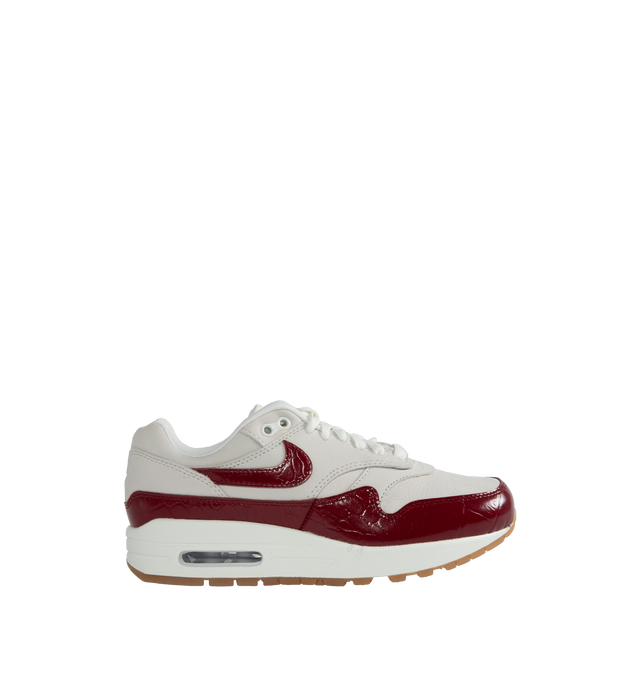 Image 1 of 5 - RED - NIKE Air Max 1 LX featuring classic wavy mudguard, foam midsole, Max Air unit in the heel, rubber waffle outsole and padded, low-cut collar. 