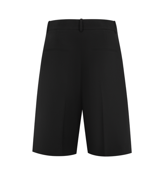 Image 2 of 3 - BLACK - KHAITE Auggie Short featuring a trouser-inspired knee-length short tailored with fluid precision in lightweight wool suiting, paired reverse pleats, belt loops, side pockets and back welt pockets. 100% virgin wool. 