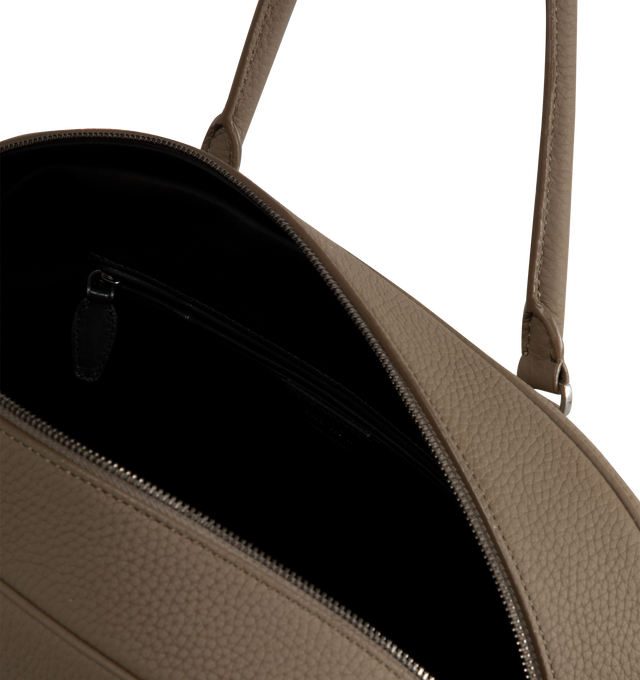 Image 3 of 3 - BROWN - The Row India 15.75 updated bowling bag in softly grained deerskin leather with tubular handles, branded metal padlock and key, and zipper closure. Measures 15.3 x 10 x 5.5 inches with 7.1 in. handle drop. Features 1 Interior zipped pocket, 1 slot pocket. 100% calfskin leather lined in 100% lambskin leather. Made in Italy. 