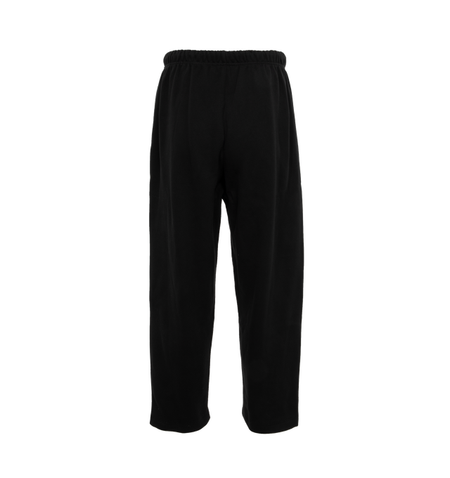 Image 2 of 4 - BLACK - Fear of God  Essentials lounge sweatpant made in core fleece and designed in a wide-leg fit for pronounced drape. Featuring rubberized label at the center front, encased elastic waistband with elongated drawstrings with rubberized tips and side seam pockets. 80% cotton, 20% polyester heavyweight fleece. 