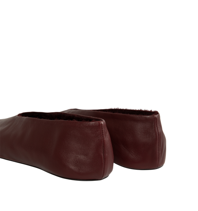 Image 3 of 4 - RED - The Row Women's Stella Slippers are crafted from smooth nappa lambskin leather and feature a slip-on silhouette with an oval toe, soft shearling lining, and a flexible rubber-coated sole. These designer leather slippers combine exceptional Italian craftsmanship with luxurious comfort, making them an elevated choice for effortless everyday wear. Main Material: 100% Lambskin Leather. Lining: Shearling. Sole: Rubber-Coated. Made in Italy. 
