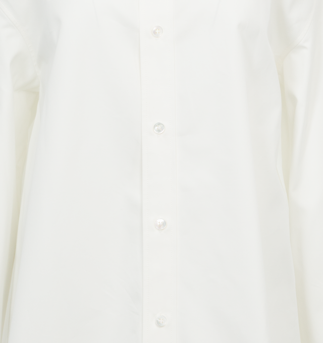 Image 3 of 3 - WHITE - Saint Laurent Oversized shirt crafted from organic cotton featuring pointed collare, drop shoulders, front-button closure, curved hem and concealed four-button cuffs. 100% cotton. Made in Italy.  