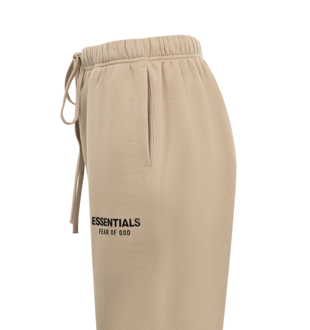 Image 3 of 3 - NEUTRAL - Fear of God Essentials Womens Sweatpants have an elastic drawstring waistband, side pockets, and a graphic screen printed on the leg. 