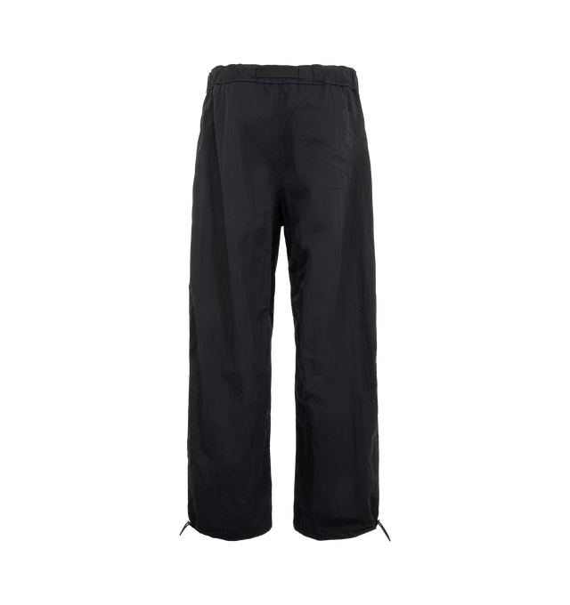 Image 2 of 3 - BLACK - Studio Nicholson Men's Caro Belted Pant is crafted from lightweight, water-repellent technical fabric and features a relaxed silhouette with an elasticated belted waistband and adjustable drawcord hems. Designed for versatile transeasonal wear, the crisp polyamide construction offers lightweight structure and everyday functionality, while the adjustable hems allow the shape to be customized for a more tapered fit. Main Material: 100% Polyamide. Made in Portugal. 