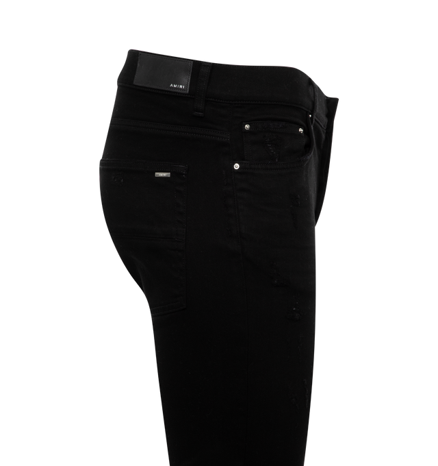Image 2 of 2 - BLACK - AMIRI MX1 Jeans featuring skinny-fit stretch denim, fading, whiskering, and subtle distressing throughout, belt loops, five-pocket styling, button-fly, underlay at front and logo-engraved silver-tone hardware. 92% cotton, 6% elastomultiester, 2% elastane. Made in United States. 
