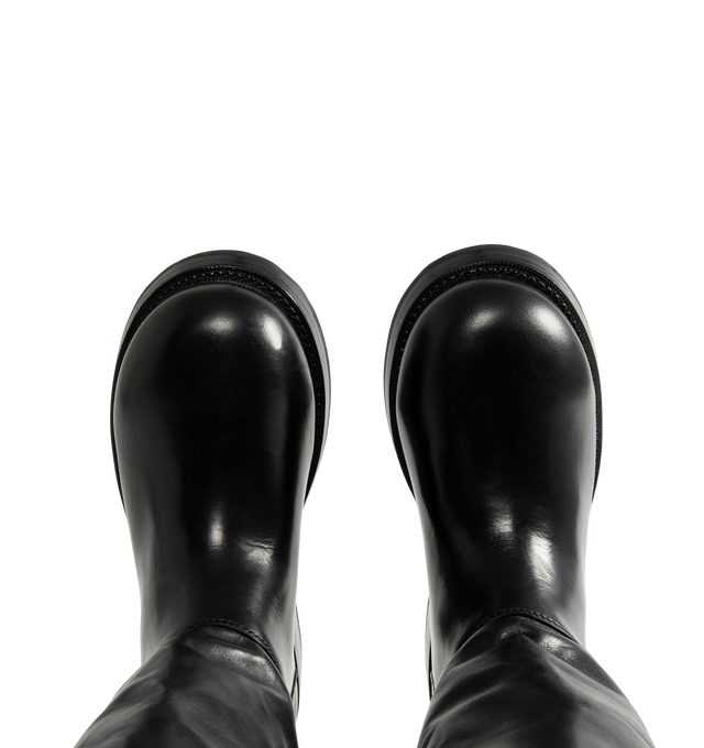 Image 4 of 4 - BLACK - Balenciaga Women's Motor Boot is crafted from calfskin leather and features a round-toe silhouette, a worn-in finish, and a sturdy Goodyear welt construction. Designed with a supple upper for versatile styling, this elevated boot is finished with an adjustable strap, a Balenciaga-engraved belt buckle, and debossed Balenciaga branding at the heel counter. Main Material: Calfskin Leather. Sole: Calfskin Rubber. Insole: Calfskin. Made in Italy. 