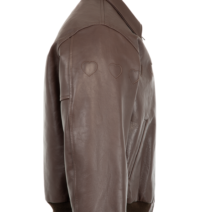 Image 3 of 3 - BROWN - Human Made Men's Leather Jacket is crafted from cow leather and features a classic silhouette with a quilted polyester taffeta lining for added comfort and warmth. Designed with heart-shaped cutout detailing across the front, this statement outerwear style is finished with signature yellow heart logos at the left chest and back, along with rib-knit cuffs and hem for a secure fit. Main Material: Cow Leather. Lining: Quilted Polyester Taffeta.  
