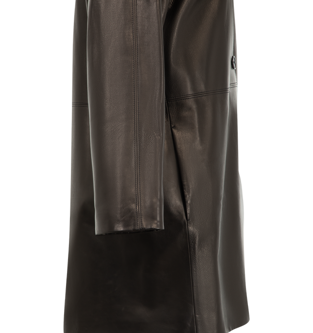 Image 3 of 3 - BLACK - The Row Women's Donata Coat is crafted from tumbled baby calfskin leather and features a mid-length car coat silhouette with a flat collar, dropped shoulders, side seam pockets, and a horn button-front closure. Fully lined in silk, this designer leather coat combines exceptional Italian craftsmanship with an exceptionally soft hand and rich natural texture, creating a timeless outerwear staple with effortless sophistication. Main Material: 100% Calfskin Leather. Lining: 100% Silk. Mad 