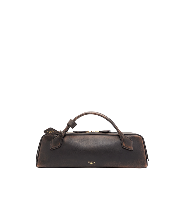 Image 1 of 1 - BROWN - ALAA clutch version of the emblematic Le Teckel bag crafted from aged leather featuring an elongated shape, tubular short handles with decorative ties, double zip closure, small removable mirror on the inside pocket.Hand carry. Dimensions (cm) : L 31 X H 10 X D 7. Made in Italy. 