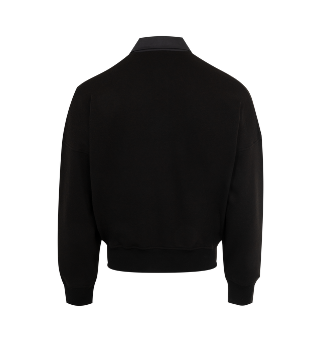 Image 2 of 2 - BLACK - THE ROW Dende Top in Cotton and Cashmere featuring oversized polo top in french terry with dropped shoulders, tonal cotton patch pocket, collar, and placket square, and ribbed cuffs and hem. 84% cotton, 16% cashmere. Made in Italy. 