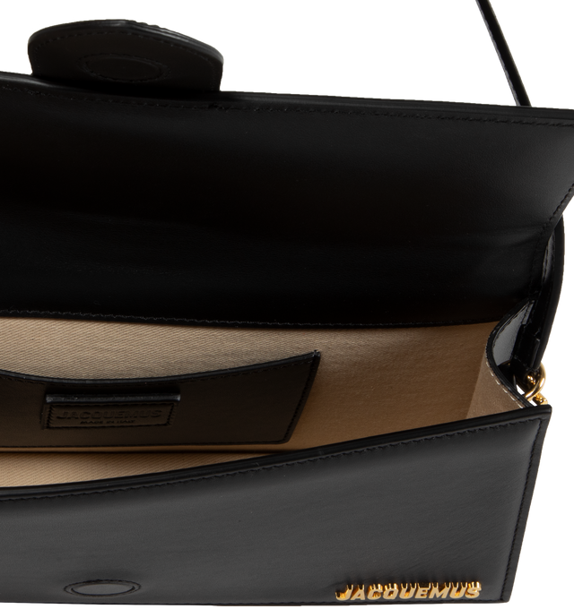 Image 3 of 3 - BLACK - JACQUEMUS Le Bambino Long Bag featuring smooth leather structured shoulder bag, magnetic flap tab closure, slim shoulder strap, back patch pocket, interior card pocket, gold metal logo and hardware, fully lined in cotton and dyed edges. 28 x 13.5 cm. 100% cowskin. Made in Italy. 