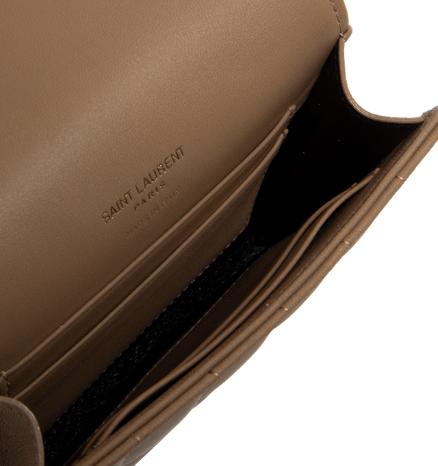 Image 3 of 3 - BROWN - SAINT LAURENT Envelope Small Wallet featuring quilted overstitching, leather lining, snap button closure, external back pocket, four card slots and one main compartment. 5.1 X 3.7 X 0.7 inches. 70% lambskin, 30% metal.  