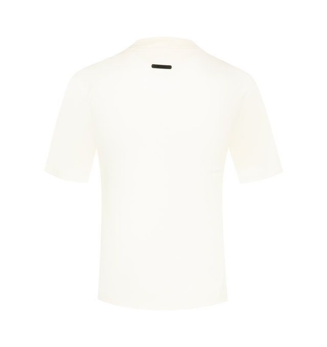 Image 2 of 2 - WHITE - Fear of God Essentials Womens Shrunken Baseball Tee is crafted from lightweight tri-blend jersey. Features a slim cropped fit, rib-knit crew neckline, raglan short sleeves, and signature Essentials label at the back collar. Main Material: 53% Cotton, 40% Polyester, 7% Rayon. 