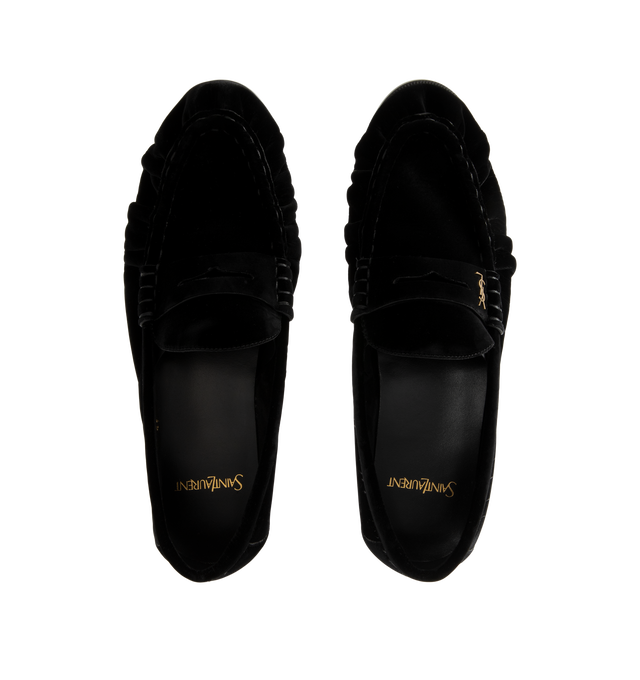 Image 4 of 4 - BLACK - Saint Laurent Men's Cassandre Velvet Penny Loafers are crafted from plush velvet and feature a supple silhouette with a hand-stitched moc toe for a refined finish. Designed with a classic penny loafer profile, these designer shoes are accented with the signature Cassandre in gold-tone brass hardware and finished with a leather sole and low stacked heel. Main Material: Velvet. Hardware: Brass. Sole: Leather. Heel Height: 1.5 cm / 0.6 in. Details: Gold-Tone Cassandre Hardware, Hand-Stit 