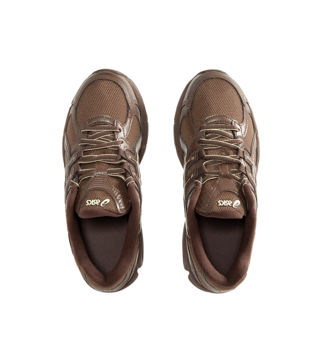 Image 5 of 5 - BROWN - Asics Unisex Emmi x Gel-Stratus MC Sneakers are crafted with synthetic leather overlays and breathable air mesh underlays and feature a streamlined silhouette inspired by technical running footwear. Designed in an exclusive Brown Storm colorway, this collaborative style is equipped with rearfoot GEL technology and GEL-JOG MC-inspired tooling for enhanced cushioning and everyday comfort. Main Material: Synthetic Leather and Mesh. Cushioning: Rearfoot GEL Technology.  