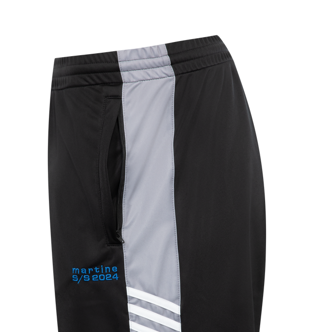 Image 3 of 3 - BLACK - MARTINE ROSE Wide Leg Track Pant in black with contrasting blue, white and grey panel details. Featuring embroidered Martine Rose logo at the front, an elasticated waistband and 2 side pockets. 100% polyester. Unisex style in Men's sizing.  