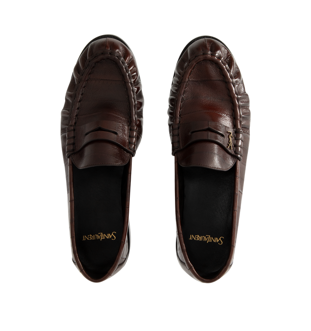 Image 4 of 4 - BROWN - Saint Laurent Mens Penny Loafers are crafted from supple eel skin leather. Feature a hand-stitched moc toe, gold-tone Cassandre hardware, classic penny loafer silhouette, and leather sole. Main Material: Eel Skin Leather; Hardware: Brass; Sole: Leather. Made in Italy. 