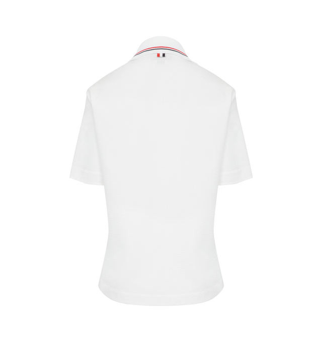 Image 2 of 2 - WHITE - THOM BROWNE Seersucker texture cotton polo top in a classic silhouette with iconic red white and blue stripe at the sides and knitted polo collar. Features front button placket, short sleeves and step hem. Cotton 100% with knit trim Cotton 95%, Polyamide 3%, Elastane 2%. Made in Italy. 