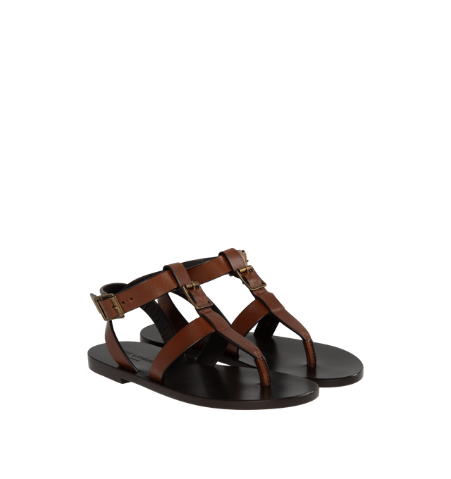Image 2 of 4 - BROWN - Saint Laurent leather sandals featuring 5 mm flat heel, thong strap with buckle accent, adjustable ankle strap with a leather outsole. Made in Italy. 
