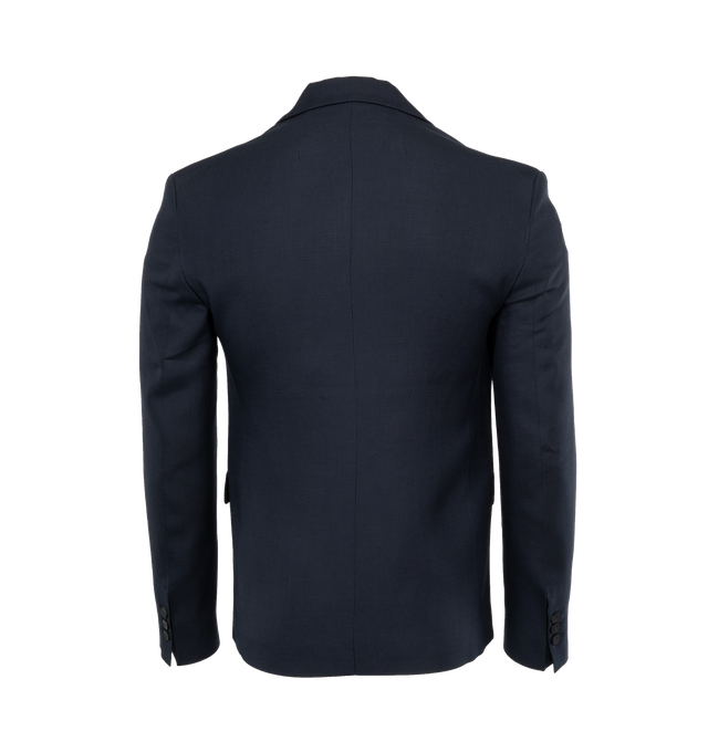 NAVY - JACQUEMUS LA VESTE MELO is a double-breasted tuxedo blazer with a straight fit with structured shoulders, notched tuxedo lapel, double-breasted with single visible button, buttoned cuffs, flap welt pockets, d-ring on the right pocket, satin lapels and piping. 100% virgin wool