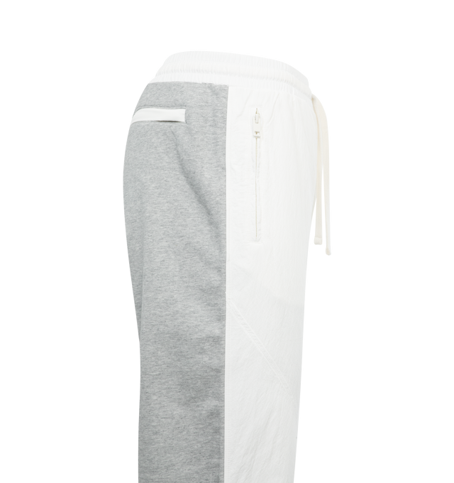 WHITE - DIESEL P-Berto Trousers featuring loose fit, elasticated drawstring waist, side zip pockets and back zip pocket and drawstring cuffs. 82% cotton, 18% polyester.