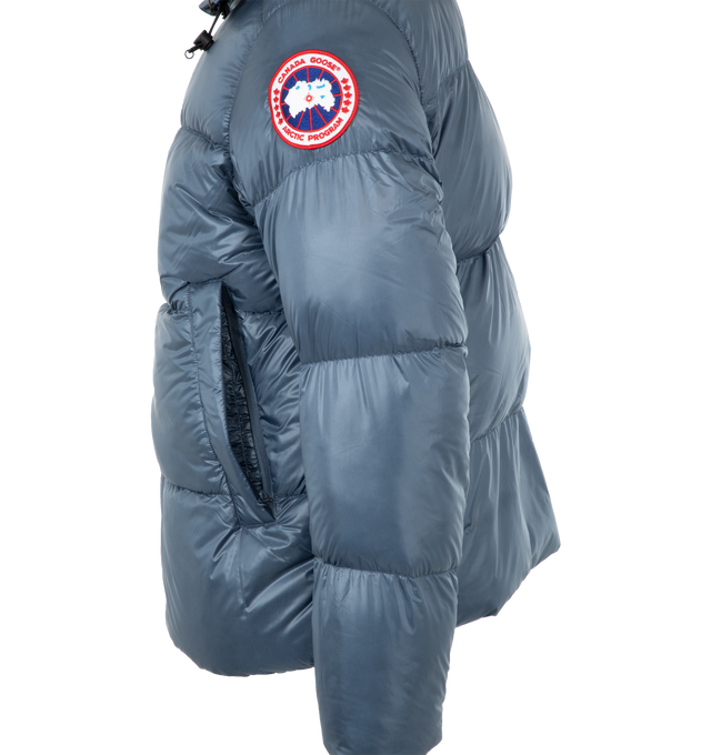 Image 3 of 3 - BLUE - CANADA GOOSE Crofton Puffer Jacket featuring packable into interior left pocket, ultra lightweight channel fill construction paired with lightweight fabrics and trims, down-filled adjustable hood with cordlock, signature double-stripe black reflective details at the back, removable elasticized interior backpack straps allow jacket to be carried hands-free over the shoulders, articulated sleeves and underarm gussets, atorm flap underneath 2-way zipper, recessed rib-knit cuffs and 2 exte 