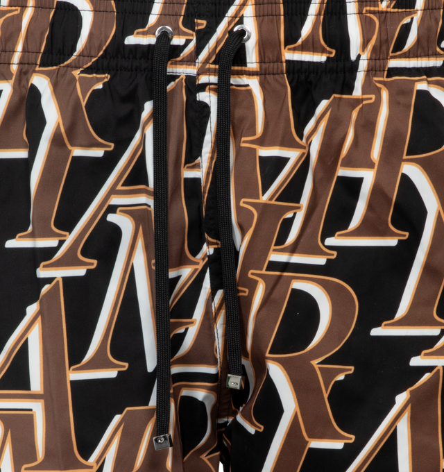 Image 4 of 4 - BLACK - AMIRI stacked logo print swim trunks featuring adjestable drawcord. Made in Italy. 90% Polyester / 10% spandex. 