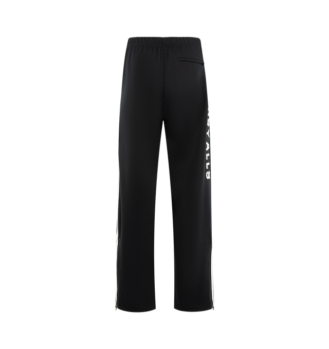 Image 2 of 4 - BLACK - HUMAN MADE Track Pants featuring straight cut with sharp front pleats, stripes down side seams, elasticated waist, two front pockets, one back pocket, vented hem and text graphic on leg. 100% polyester. 
