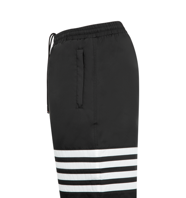 Image 3 of 3 - BLACK - THOM BROWNE Shiny Ripstop 4 Bar Track Pant featuring elasticated waistband with internal drawstring, zip fly, hand pockets and back pocket with hidden zips, elasticated cuffs, mesh lining, 4-bar detailing and signature striped grosgrain loop tab. 81% polyamide, 19% polyester. Made in Italy. 