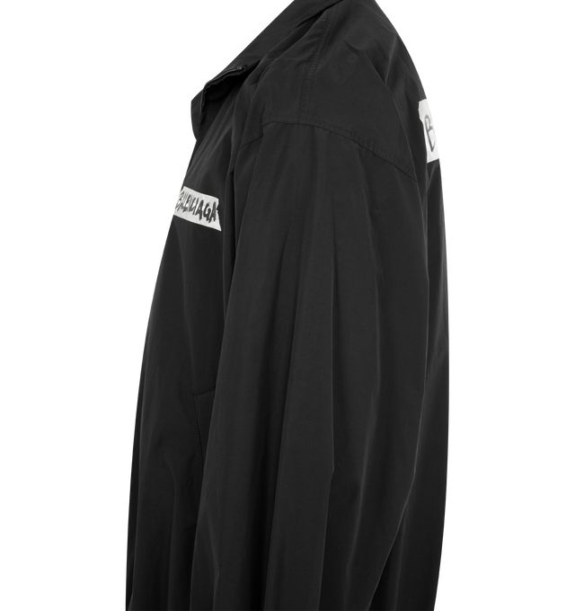 Image 3 of 3 - BLACK - BALENCIAGA Masking Tape Tracksuit Jacket Medium Fit in black techno cotton poplin featuring techno cotton poplin, double-ended zip fastening, long sleeves, 2 zipped slash pockets, gathered at cuffs and waistline and masking tape artwork at chest and back. 50% cotton, 50% polyamide. Lining: 100% polyester. Made in Italy. 
