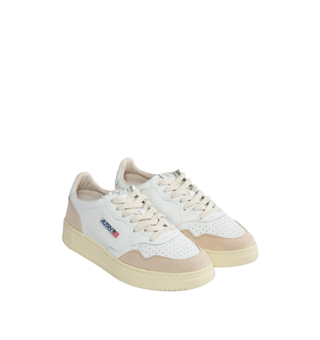 Image 2 of 5 - WHITE - AUTRY Medalist Low Sneaker featuring perforated toe, flat cotton laces, tonal label seamed on a textile tongue, padded ankle collar and back patch with embossed logo. Upper in leather and suede. Leather and cotton terry lining. 2 cm-high raised sockliner in leather. Color matched sole in rubber with logo. 
