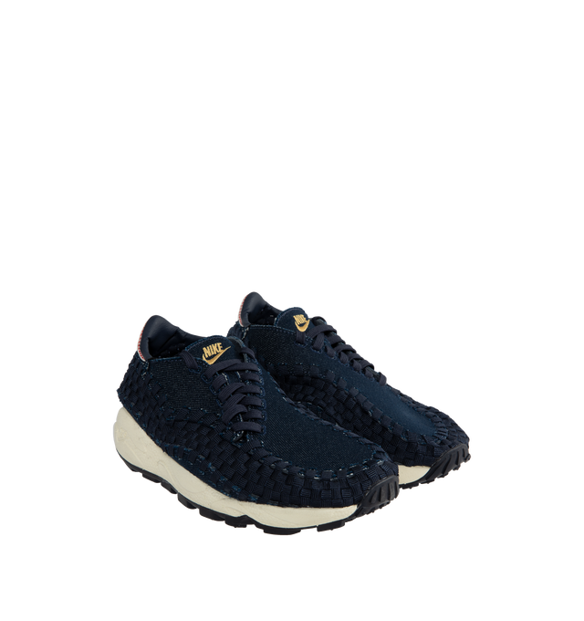 Image 2 of 5 - NAVY - NIKE Air Footscape Woven Sneakers featuring a blue denim colored textile and soft suede upper, asymmetrical woven details, lateral lacing, foam midsole, Nike Air cushioned heel and rubber outsole. 