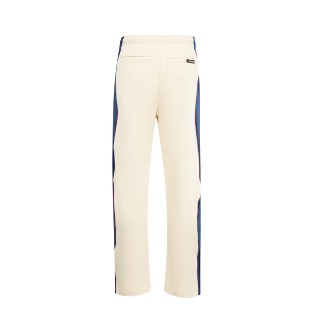 Image 2 of 3 - WHITE - NAHMIAS Ollie Sweatpants featuring elastic waist with drawstring, side pockets, two back welt pockets, logo on leg, stripes and piping down leg, loose fit and bungee cord at hem. 100% cotton.  
