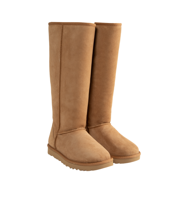 Image 2 of 4 - BROWN - Ugg Women's Classic Ultra Tall Boot is a sky-high version of the iconic style. Featuring a 15-inch shaft height, plush sheepskin lining, and an ultra-lightweight rubber outsole for comfort. Main Material: 17mm Twinface Sheepskin. Lining: 17mm Sheepskin. Insole: 17mm Sheepskin. Sole: Sugarcane EVA. Details: Overlock Stitch Seams.  