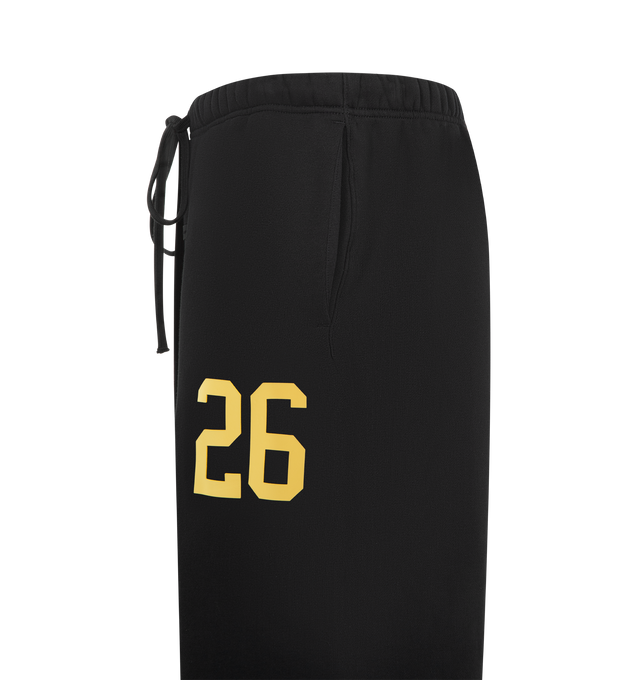 Image 3 of 3 - BLACK - FEAR OF GOD ESSENTIALS Lounge Sweatpant featuring core fleece treated with a vintage wash, wide-leg silhouette, a 26 HD print graphic on the leg, encased elastic waistband with elongated drawcords, side seam pockets and a Fear of God Essentials rubberized label stitched at the center front. 100% cotton.  