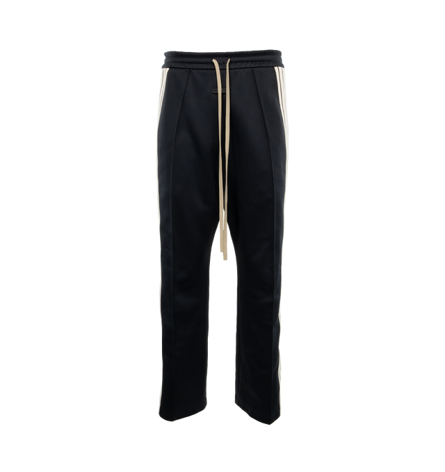Image 1 of 3 - BLACK - FEAR OF GOD Stripe Relaxed Sweatpant featuring a relaxed fit with a pintuck stitch to shape the leg and a sports-inspired canvas side stripe, pockets, encased elastic waistband, elongated drawstrings and Fear of God leather label at the center front. 60% nylon, 40% cotton. 