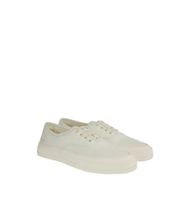 Image 2 of 5 - WHITE - Common Projects Four Hole Lace-Up Sneakers in a low-top design with flat sole, front lace-up fastening, round toe detailed with signature gold number stamp at the heel. Made in Italy. 