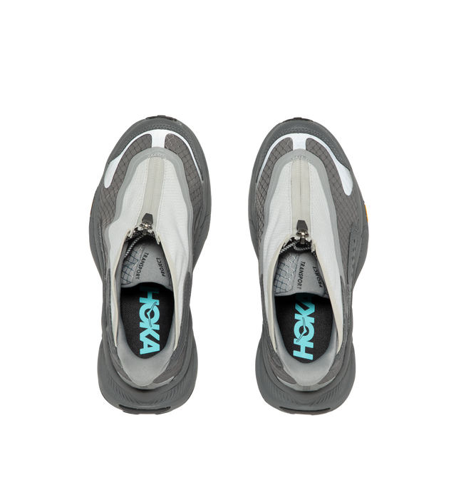 Image 5 of 5 - GREY - Hoka Project Transport Sneakers feature a shrouded ripstop upper with textured synthetic overlays for lightweight durability and a sleek, modern look. Designed for everyday wear, these performance sneakers include a quick-lace system with a zippered shroud, reflective details, signature HOKA cushioning, and a Vibram Ecostep outsole for reliable traction and lasting comfort. Main Material: Ripstop Textile and Synthetic. Sole: Vibram Rubber. Made in Vietnam. 