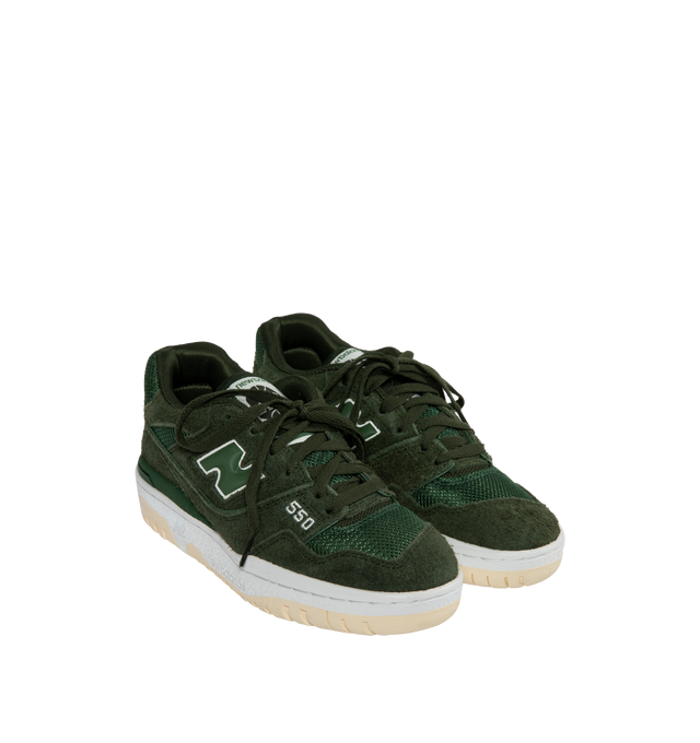 Image 2 of 5 - GREEN - The New Balance 550 debuted in 1989 and made its mark on basketball courts from coast to coast. Returning from the archives, this global fashion favorite features a low top, streamlined silhouette with leather, synthetic, and mesh upper and rubber outsole for traction and durability. 