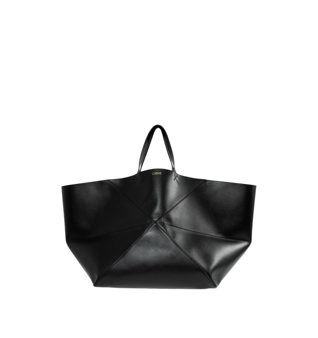 Image 1 of 3 - BLACK - XXL Puzzle Fold Tote in shiny calfskin takes the iconic bags signature geometric lines and reimagines them in graphic and architectural panels that allow the bag to fold completely flat, making it the perfect travel companion. Soft, lightweight and inventively crafted, it is finished with discreet LOEWE branding. This XXL version is crafted in shiny calfskin with gold embossed LOEWE and suede lining. Hand carry. 