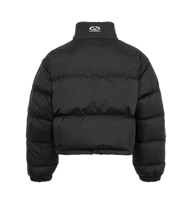 Image 2 of 3 - BLACK - VETEMENTS Puffer Jacket crafted with premium polyester layers and plush down filling featuring two zippered pockets, short, oversized fit with wide sleeves, logo at the chest, front zipper closure and elasticated cuffs. Polyester with down filling. 