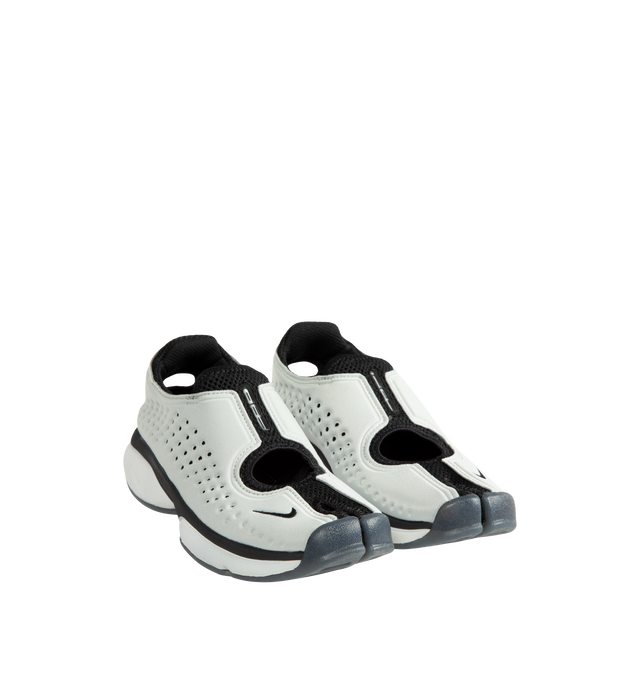 Image 2 of 5 - WHITE - Nike Women's Rift II Sneakers are a one-to-one reissue of the sought-after 2002 update to the iconic Air Rift and feature a streamlined slip-on silhouette, a flexible upper with breathable mesh underlays, and the signature split-toe design. This lightweight sneaker revives a cult-favorite look while maintaining the performance-inspired details that made the original a standout. Main Material: Textile and Synthetic Upper with Mesh Underlays.  