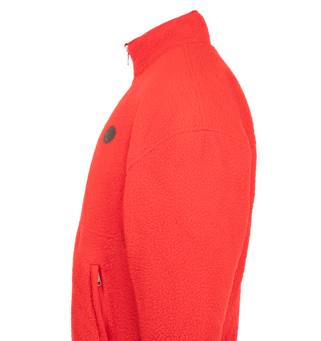 Image 3 of 3 - RED - The Willy Reversible Fleece is cut in an oversized silhouette with a stand collar and adjustable hem for a relaxed, customizable fit. Designed to be worn two ways, the reversible construction features a plush fleece exterior and smooth nylon interior, with branded zip pockets on both sides. 
