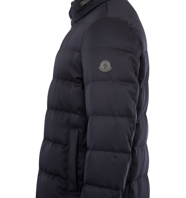 Image 4 of 5 - NAVY - MONCLER Vallonpierre Hooded Long Down Jacket featuring Aquaflect, nylon lining, down-filled, detachable and adjustable hood, collar with leather trim, zipper and snap button closure, pockets with zipper and snap button closure, adjustable cuffs, hem with drawstring fastening and leather logo patch. 100% virgin wool. Lining: 100% polyester. Padding: 90% down, 10% feather. Made in Romania. 